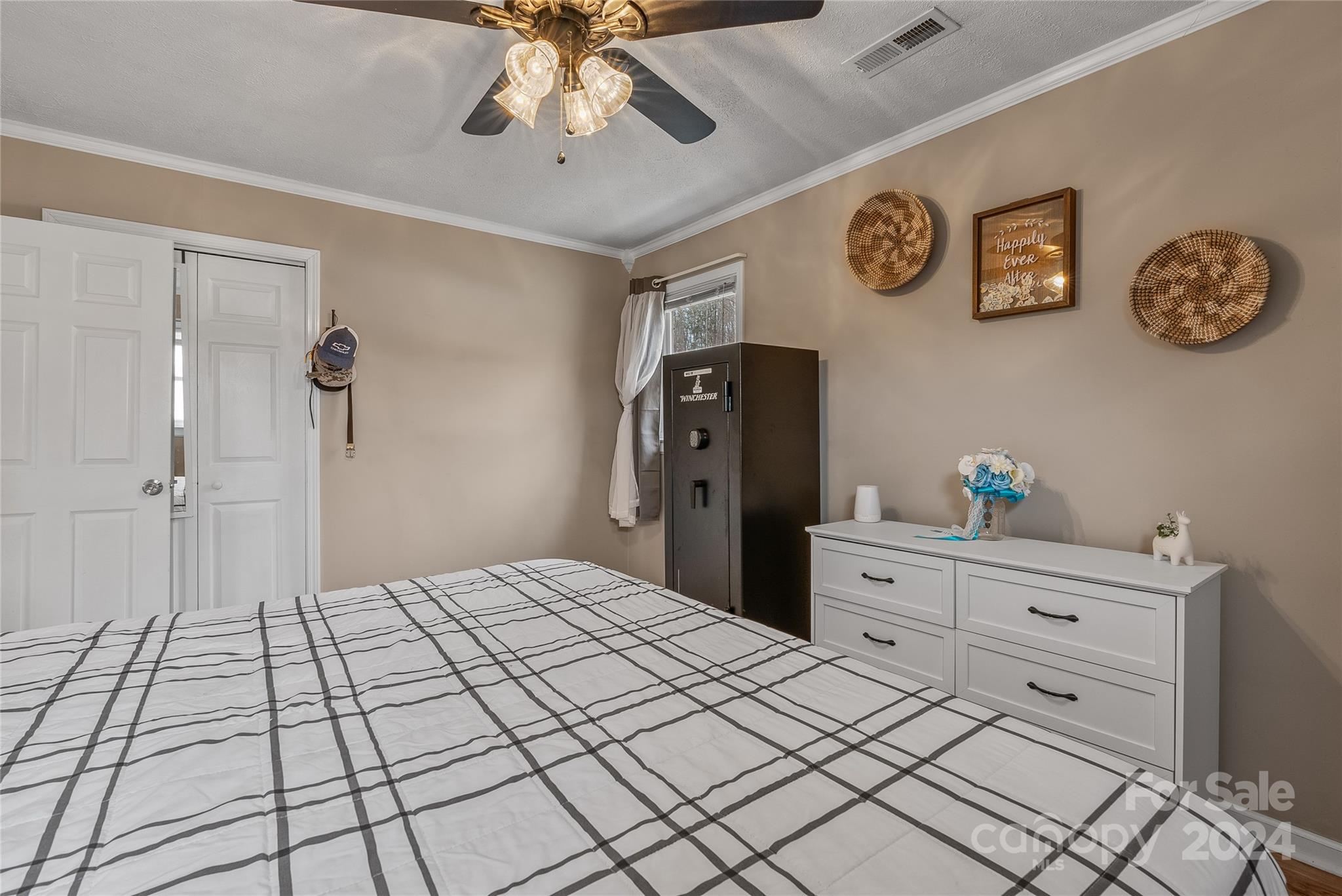 242 Maple Creek Road Rutherfordton, NC 28139 - Photo 29 of 37 a bedroom with a large bed and a chandelier