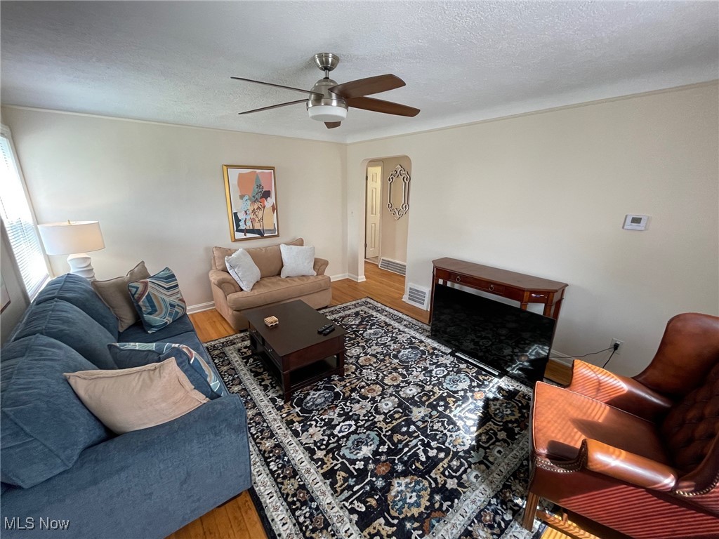 1539 Winchester Road Lyndhurst, OH 44124 - Photo 9 of 21 Living room with a textured ceiling, wood-type flooring, and ceiling fan
