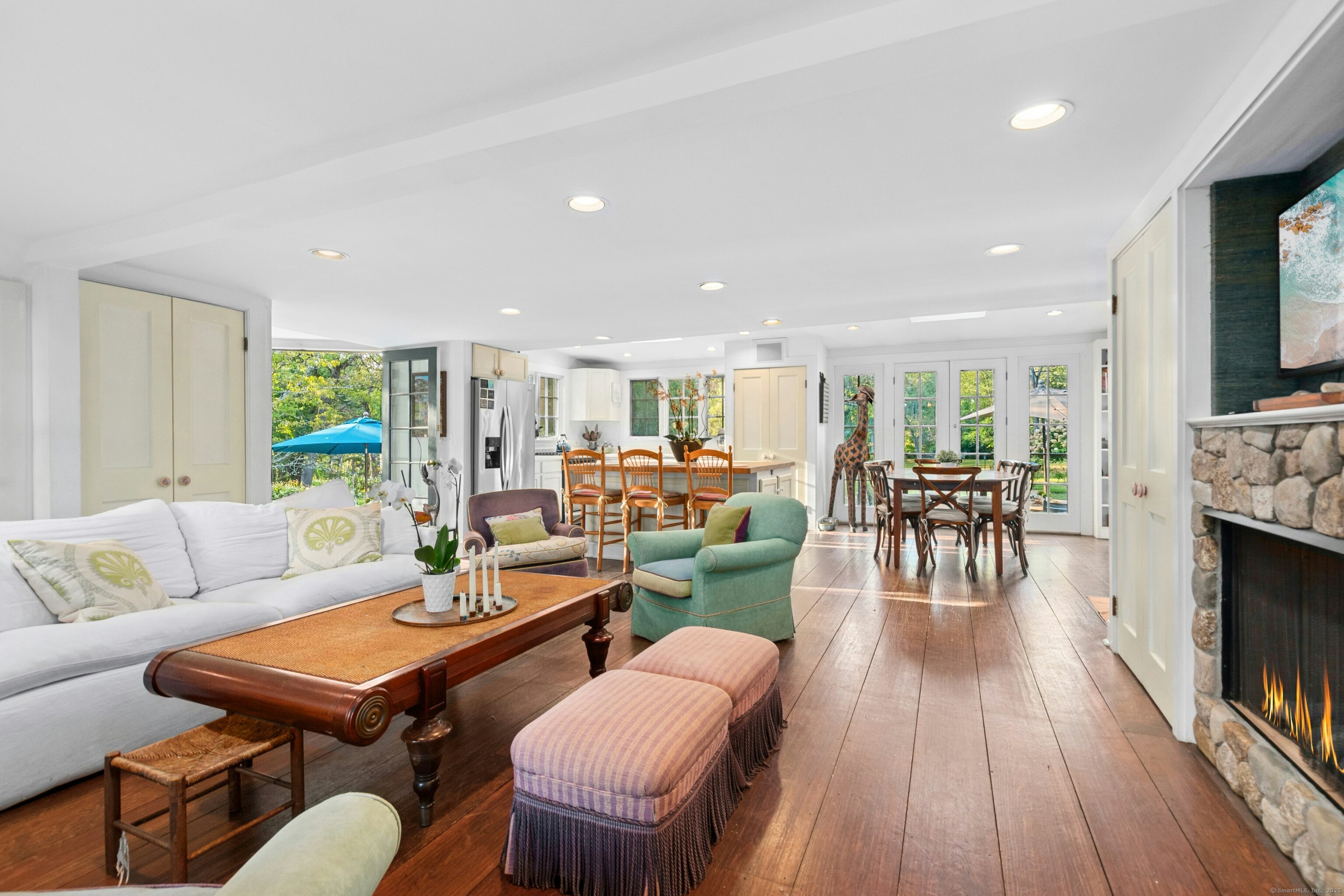 561 Middlesex Road Darien, CT 06820 - Photo 16 of 34 a living room with furniture kitchen view and a fireplace