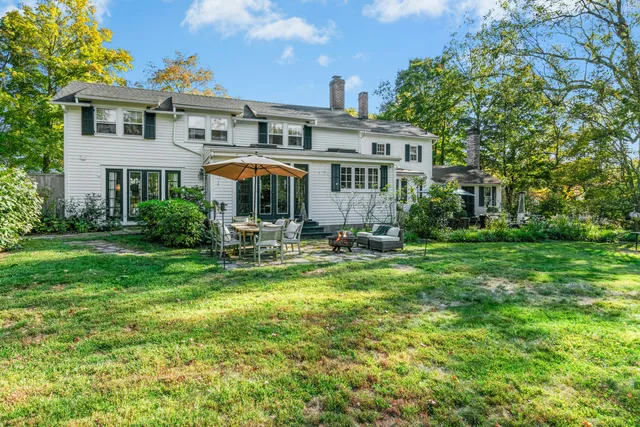 a front view of a house with yard and green space