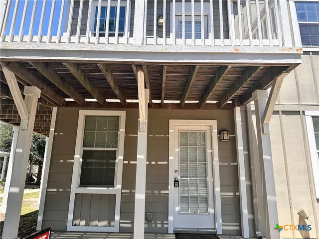 a view of porch with a door and a glass door