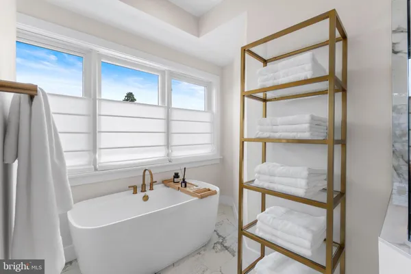 a bedroom with a bed and a large mirror
