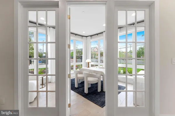 a bathroom with a toilet a sink a large mirror and a shower