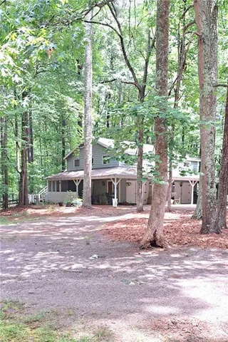 a front view of a house with garden and patio