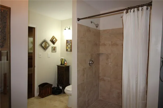 a bathroom with a shower and a sink
