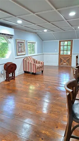 a view of a livingroom with furniture and hardwood floor