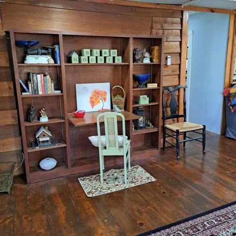 a living room with furniture and a book shelf