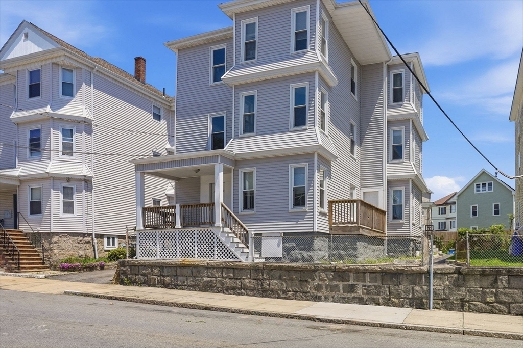 196 Irving Street Fall River, MA 02723 - Photo 1 of 34 a front view of a house with a yard