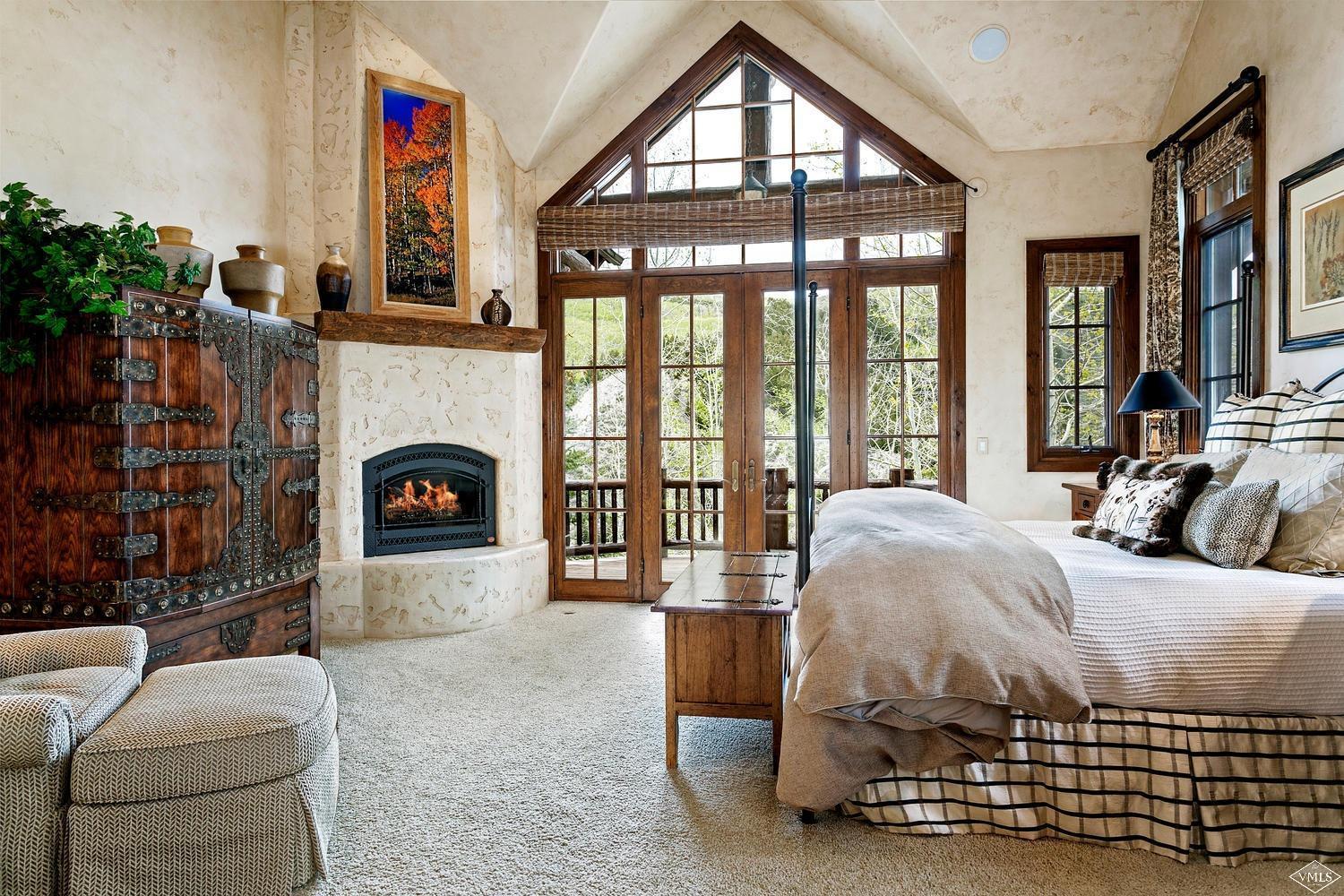 2156 Cresta Road Edwards, CO 81632 - Photo 17 of 25 a bed room with a bed and a fireplace