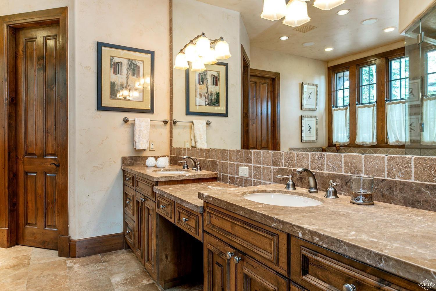2156 Cresta Road Edwards, CO 81632 - Photo 18 of 25 a bathroom with a granite countertop sink a large mirror and a shower