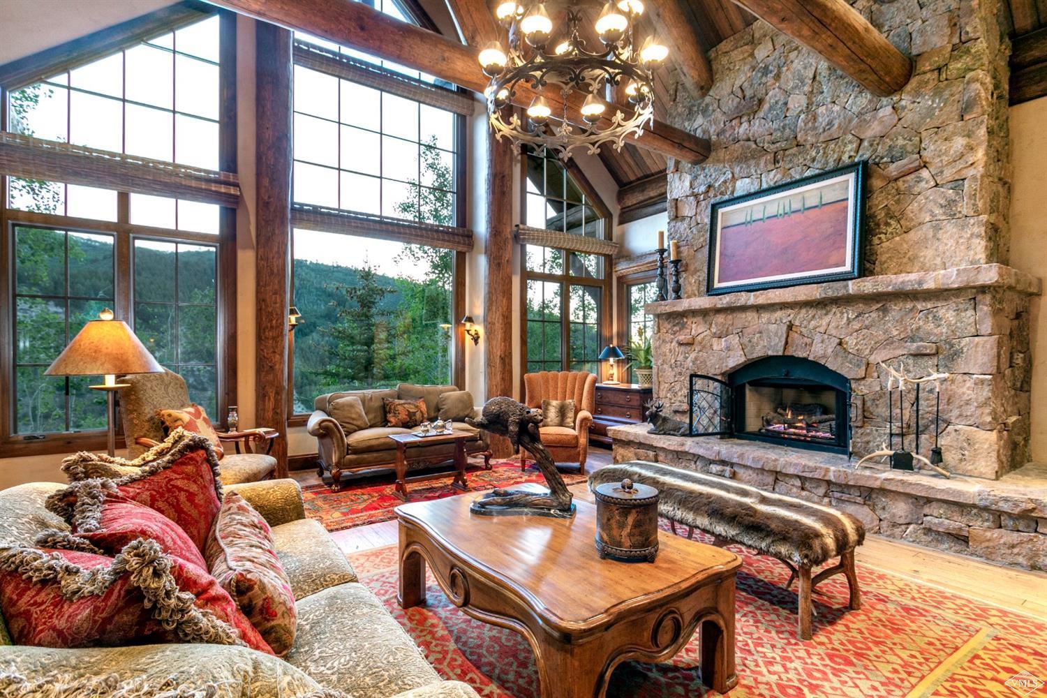 2156 Cresta Road Edwards, CO 81632 - Photo 4 of 25 a living room with furniture a large window and a fireplace