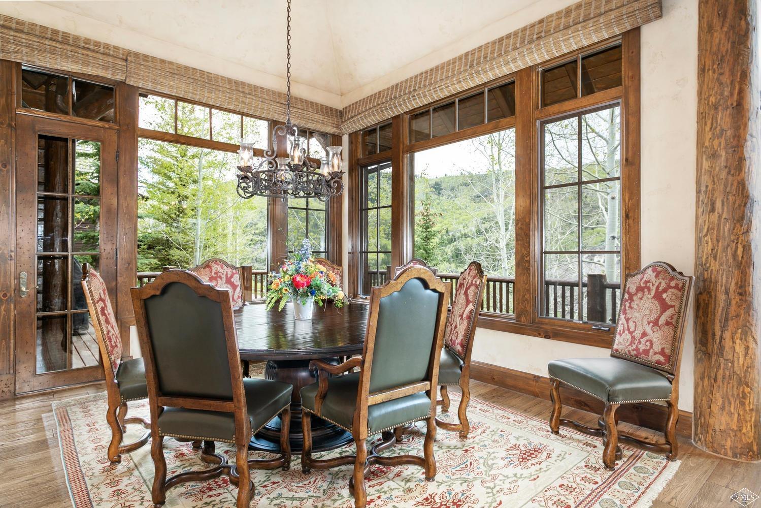 2156 Cresta Road Edwards, CO 81632 - Photo 8 of 25 a dining room with furniture large windows and wooden floor