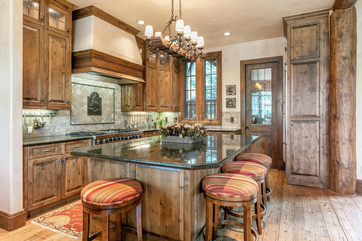 2156 Cresta Road Edwards, CO 81632 - Photo 10 of 25 a kitchen with sink a refrigerator and chandelier