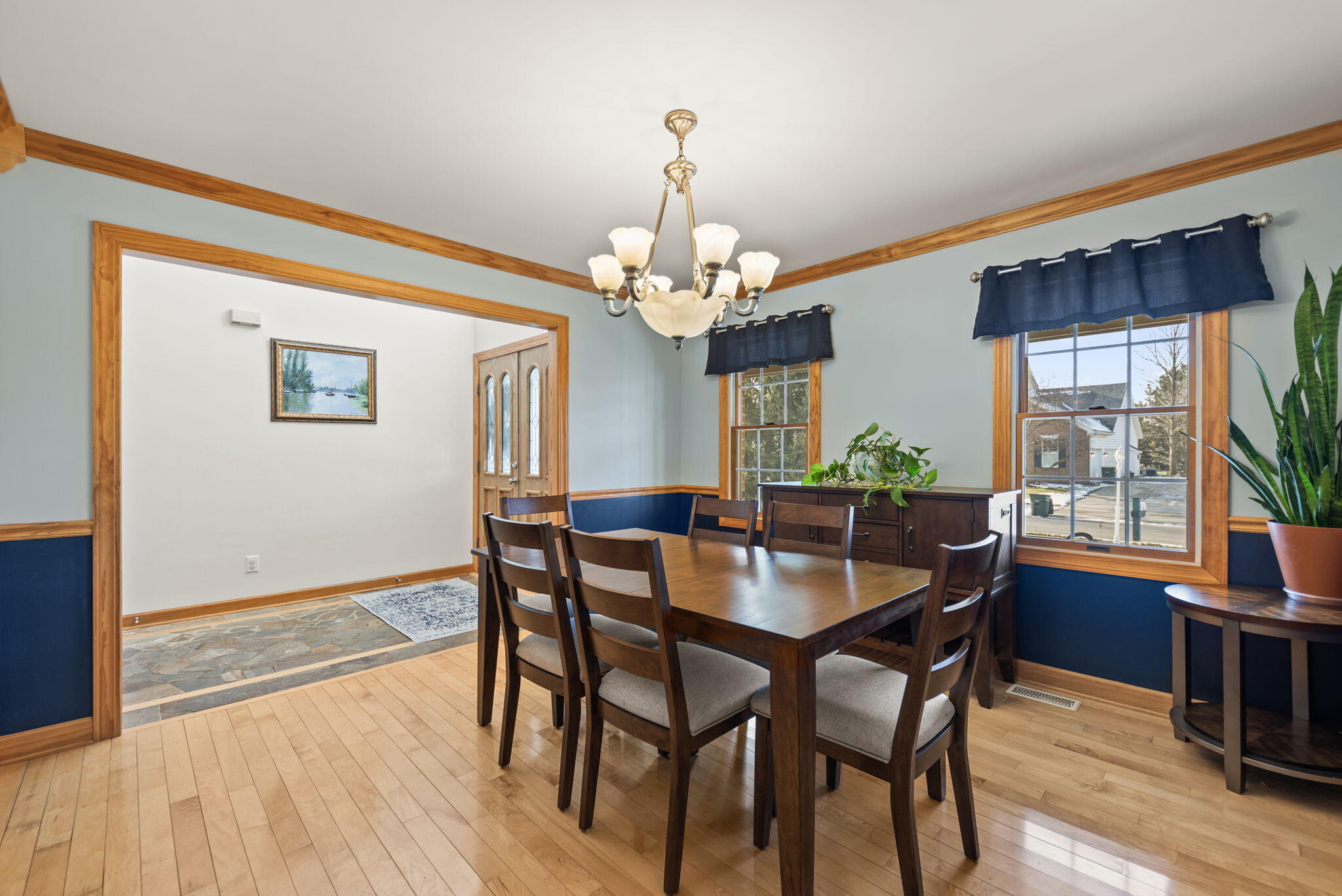 3102 Coachman Trail Valparaiso, IN 46385 - Photo 5 of 33 a dining room with wooden floor a chandelier a wooden table and chairs