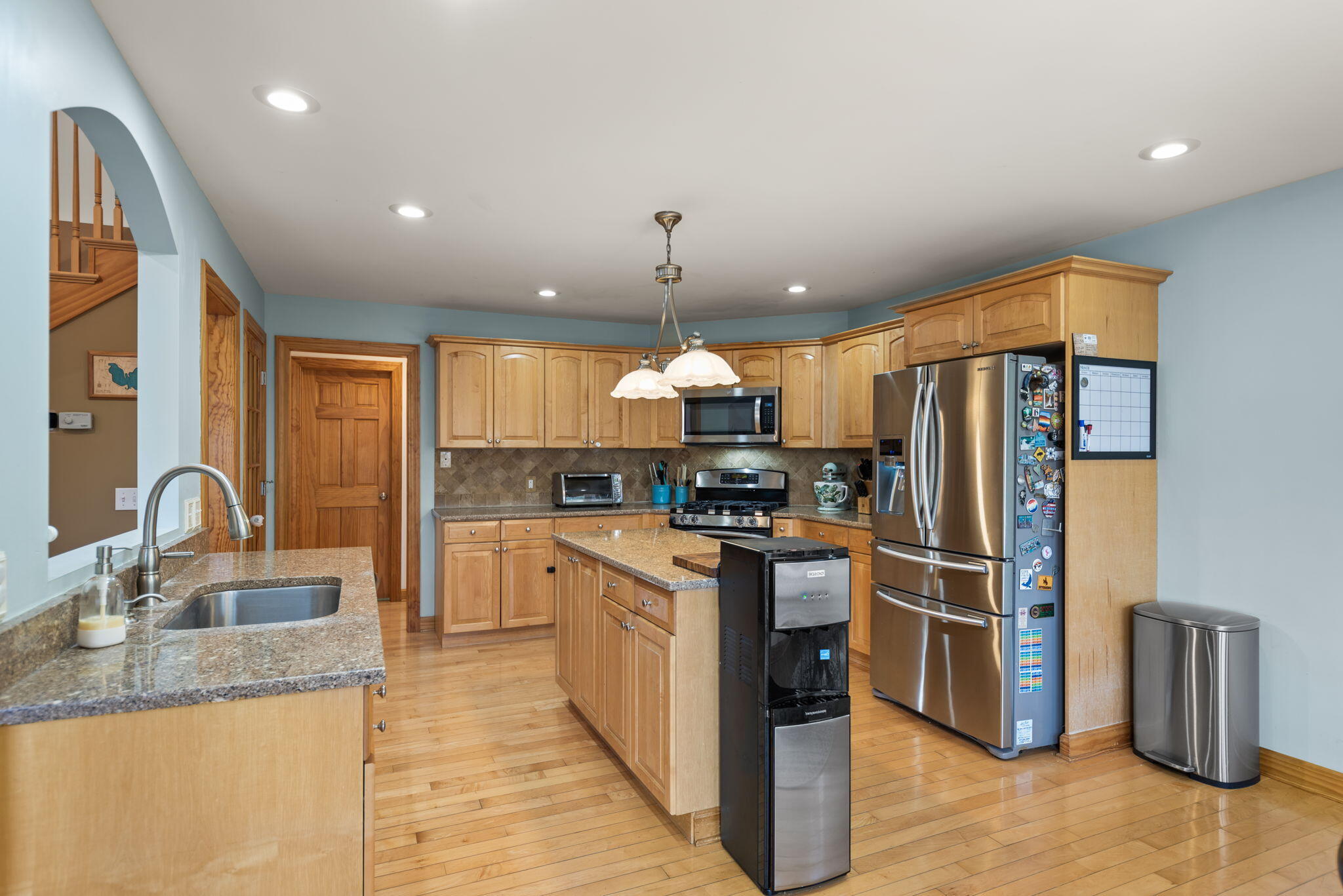 3102 Coachman Trail Valparaiso, IN 46385 - Photo 8 of 33 a kitchen with stainless steel appliances granite countertop a sink refrigerator and cabinets