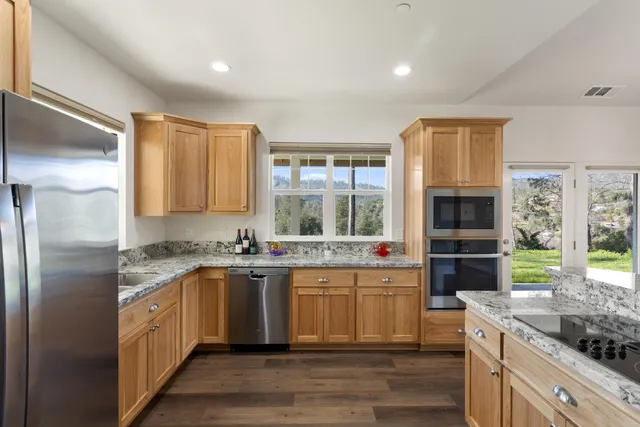 a kitchen with a sink stove and refrigerator