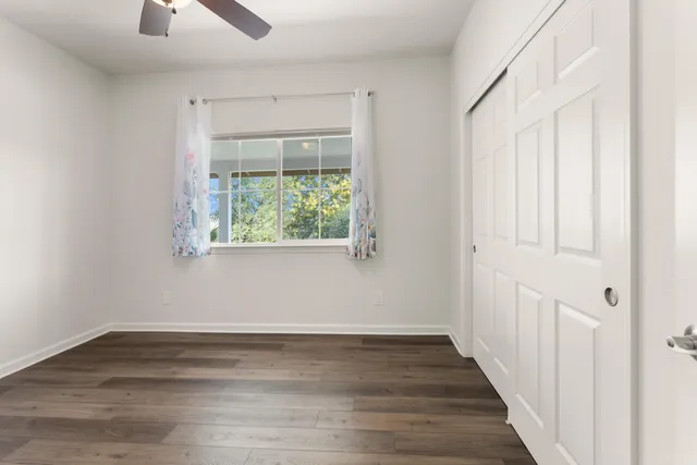 wooden floor in an empty room with a window