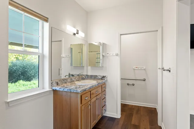a bathroom with a sink a mirror and a shower