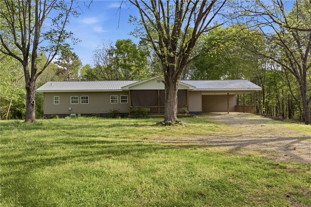 6668 Belton Bridge Road Lula, GA 30554 - Photo 19 of 29 a front view of a house with a garden and trees