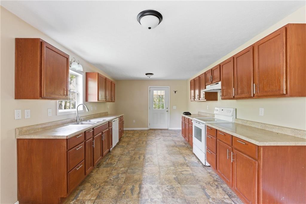 6668 Belton Bridge Road Lula, GA 30554 - Photo 22 of 29 a large kitchen with stainless steel appliances granite countertop a sink and cabinets