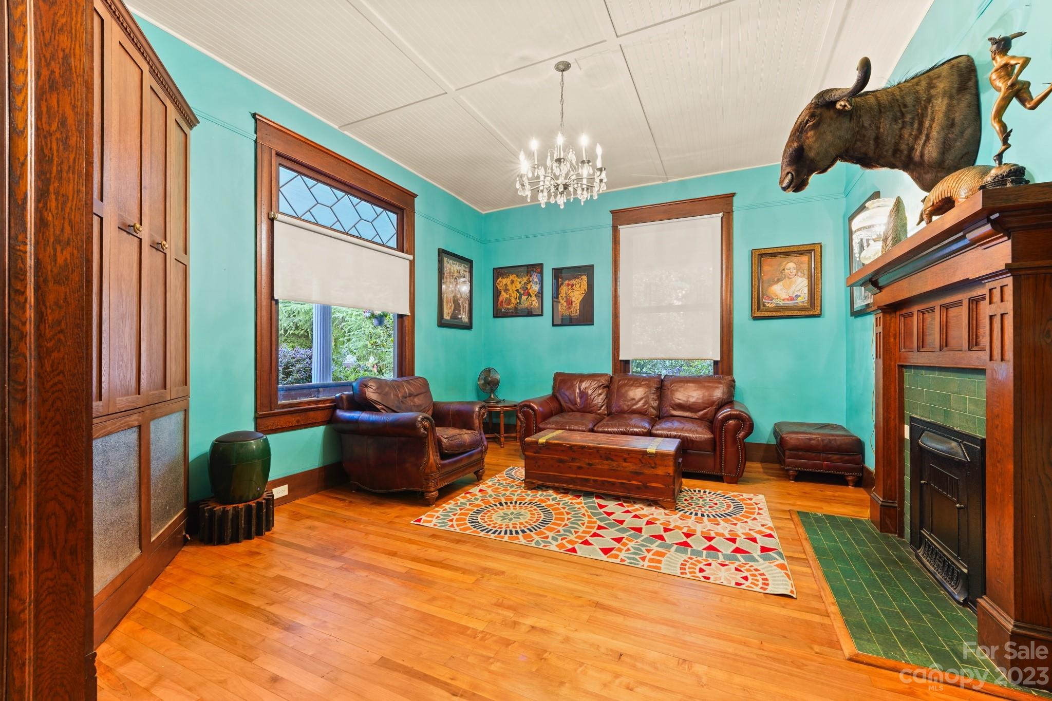 810 East Franklin Street Monroe, NC 28112 - Photo 14 of 47 a living room with furniture a fireplace and a chandelier