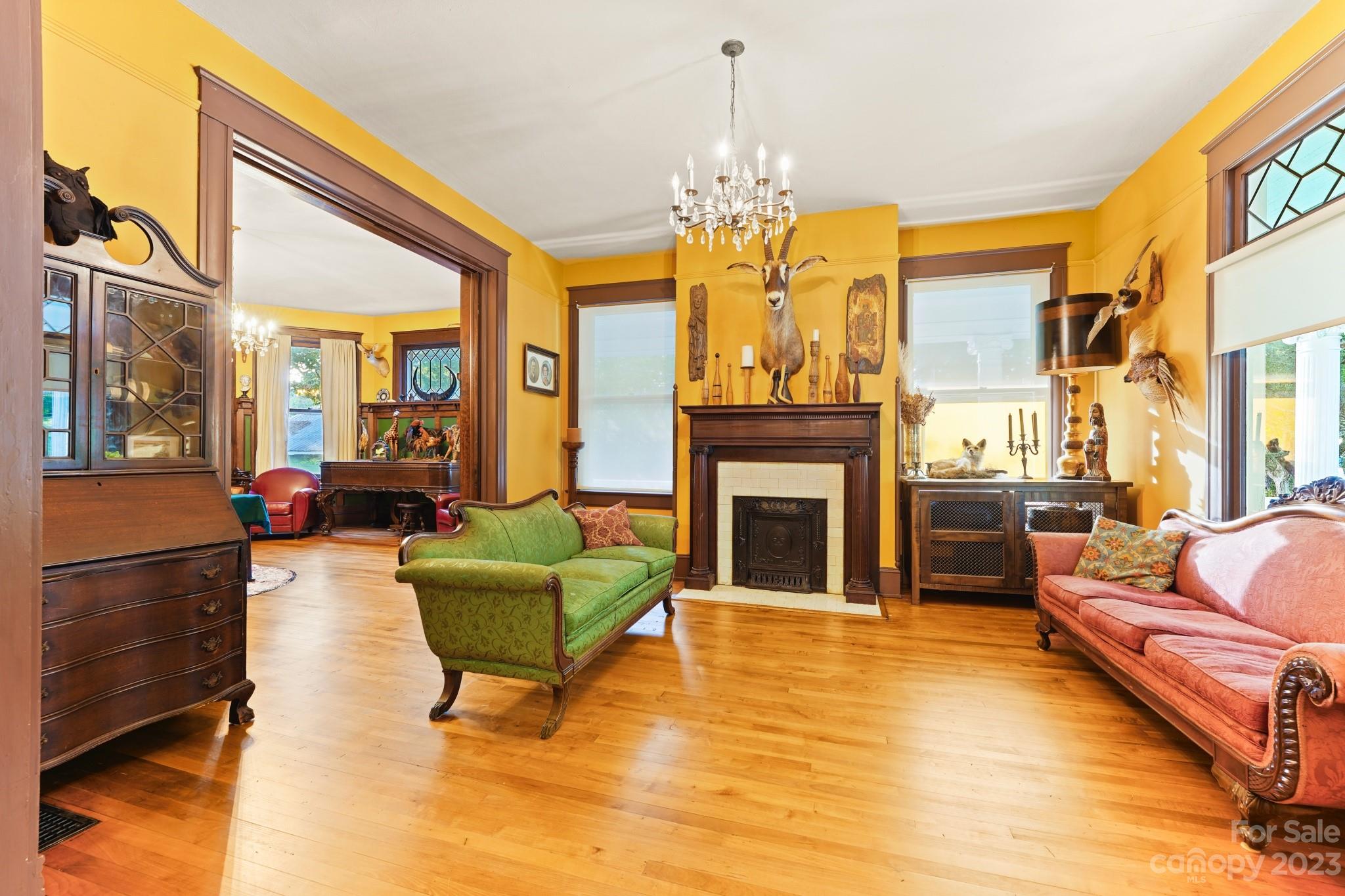 810 East Franklin Street Monroe, NC 28112 - Photo 16 of 47 a living room with furniture a chandelier and a fireplace