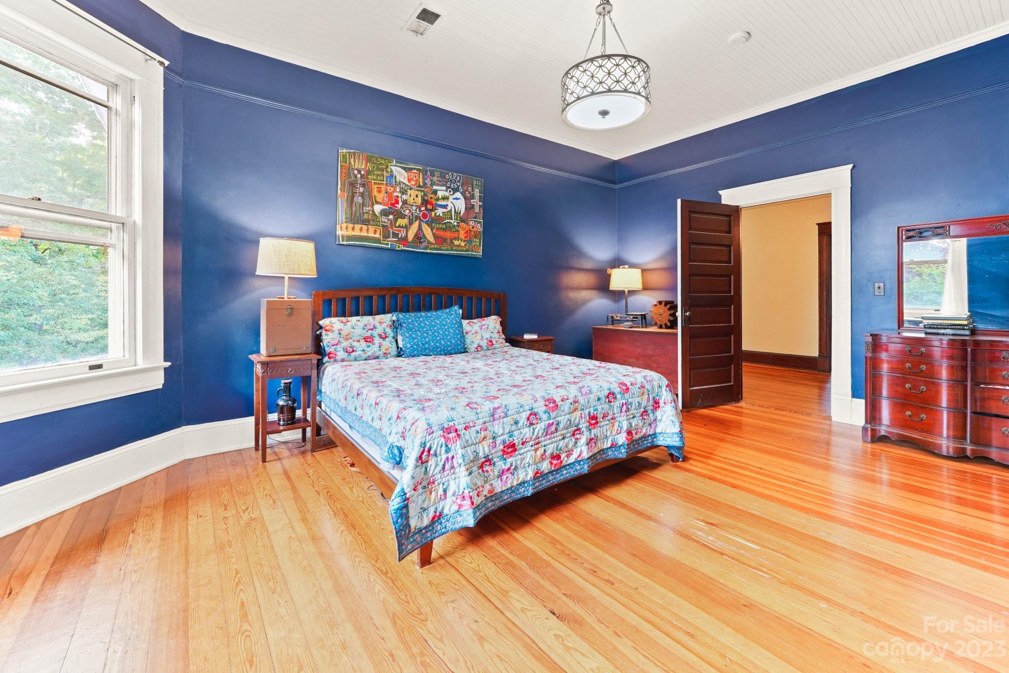 810 East Franklin Street Monroe, NC 28112 - Photo 19 of 47 a bedroom with a bed and wooden floor