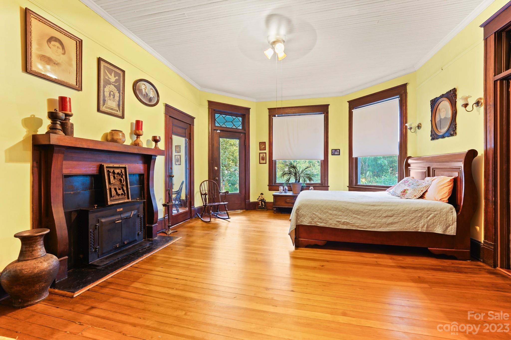 810 East Franklin Street Monroe, NC 28112 - Photo 26 of 47 a spacious bedroom with a bed and wooden floor
