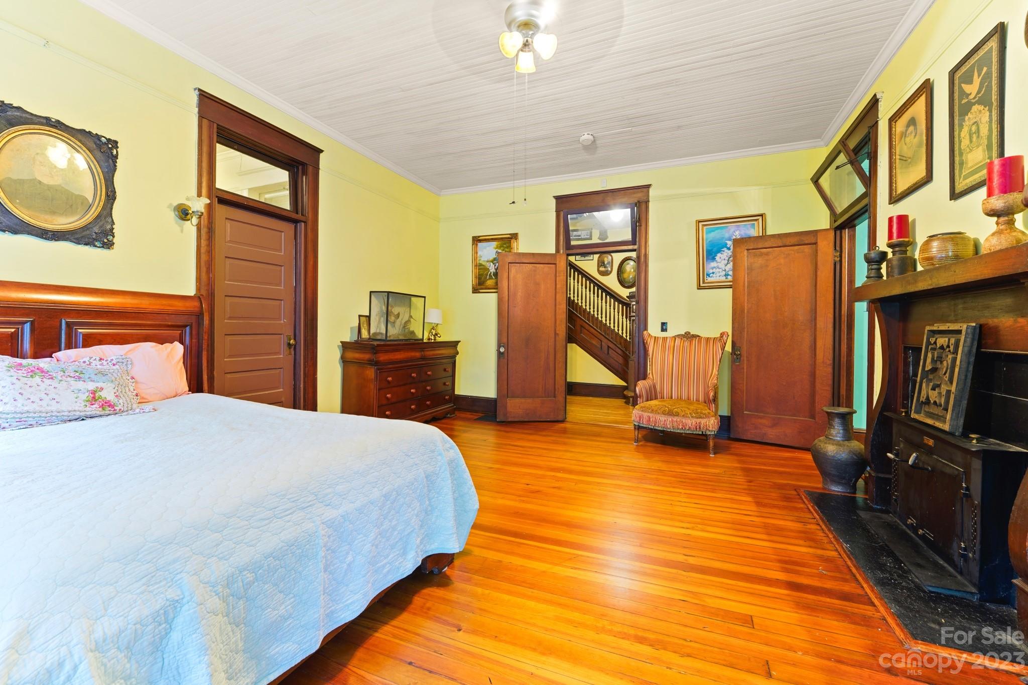 810 East Franklin Street Monroe, NC 28112 - Photo 27 of 47 a bedroom with a bed a flat screen tv and dresser