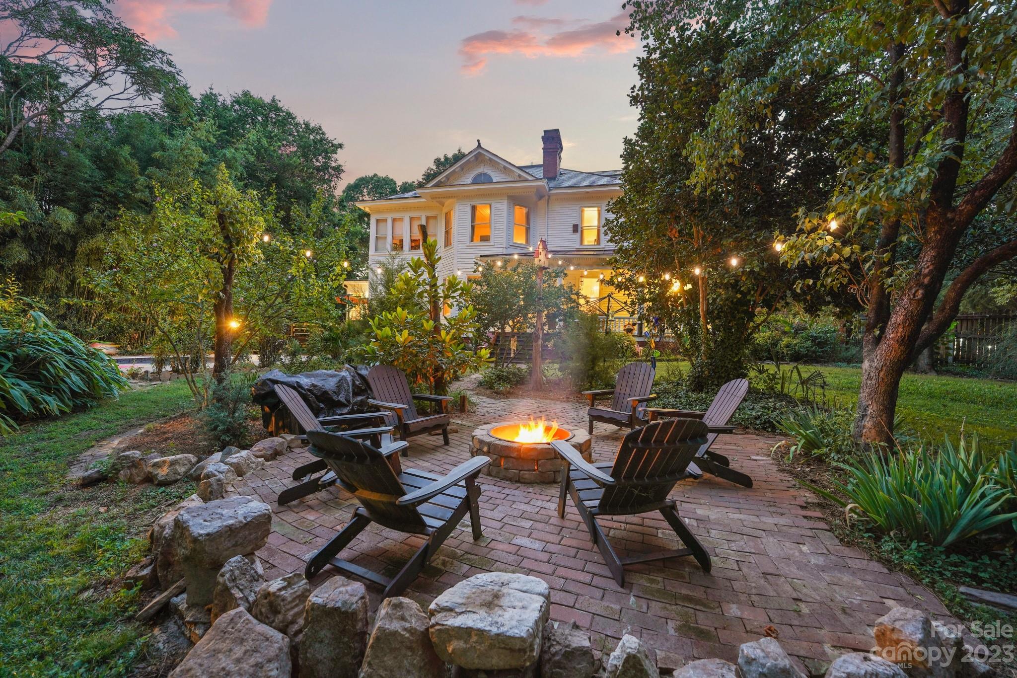 810 East Franklin Street Monroe, NC 28112 - Photo 6 of 47 a view of a patio with table and chairs and potted plants