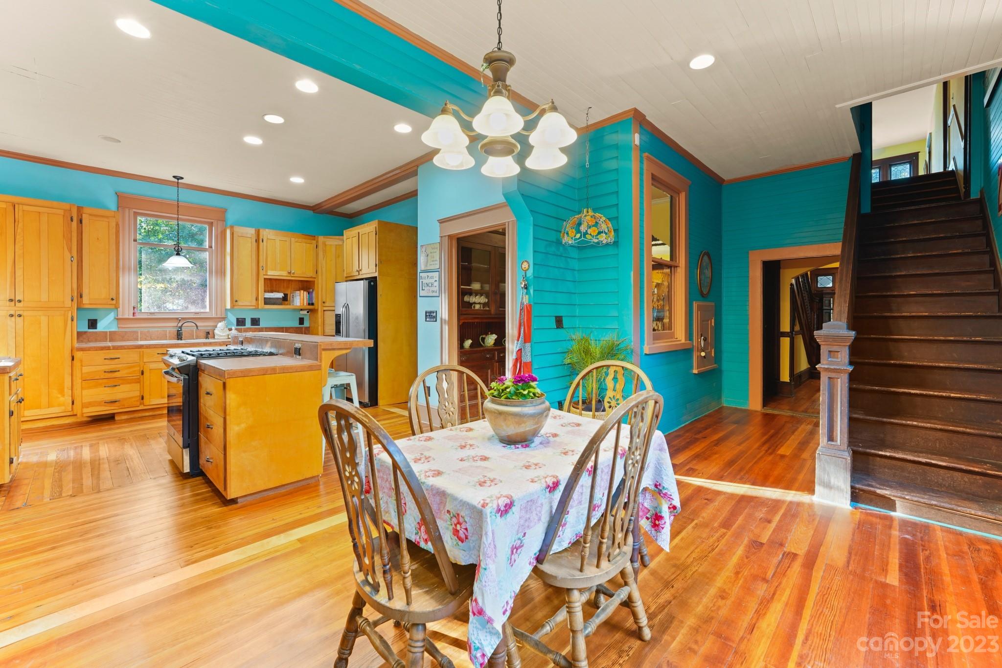 810 East Franklin Street Monroe, NC 28112 - Photo 10 of 47 a dining room with stainless steel appliances furniture a chandelier and a kitchen view