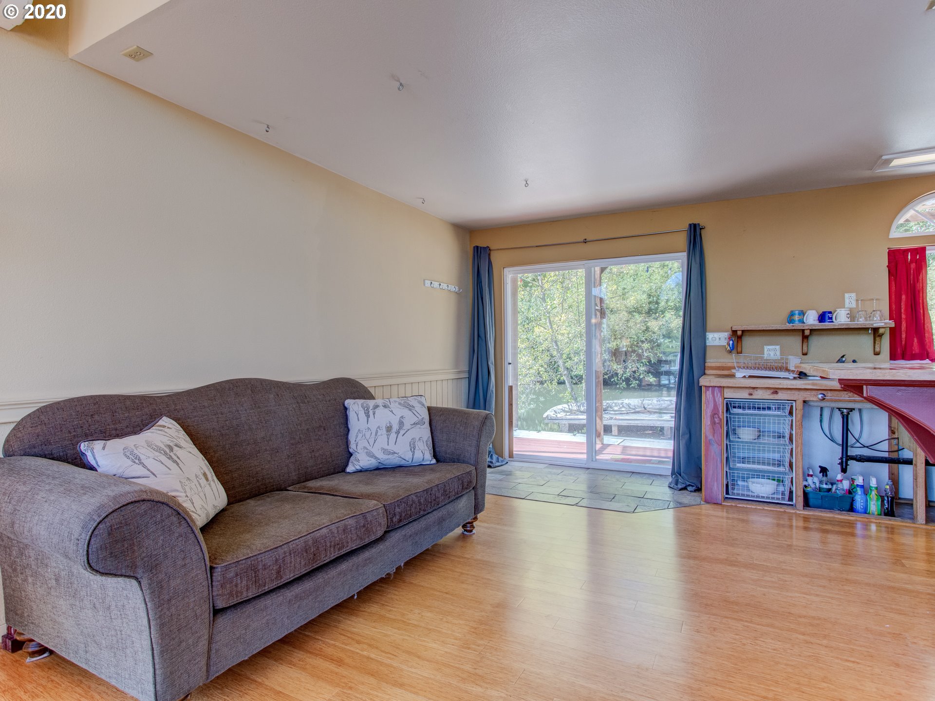 14998 Northwest Mill Road, Unit D Portland, OR 97231 - Photo 16 of 32 a living room with a couch and a large window