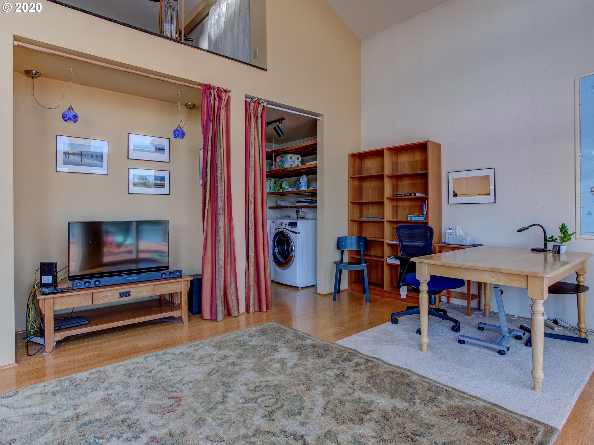 14998 Northwest Mill Road, Unit D Portland, OR 97231 - Photo 22 of 32 a living room with furniture a rug and a flat screen tv
