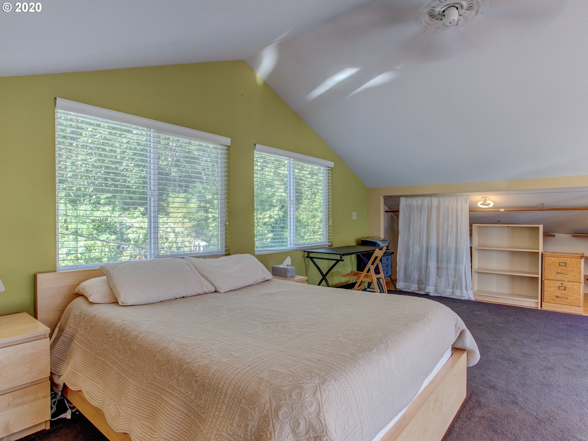 14998 Northwest Mill Road, Unit D Portland, OR 97231 - Photo 23 of 32 a bed sitting in a spacious bedroom next to a window