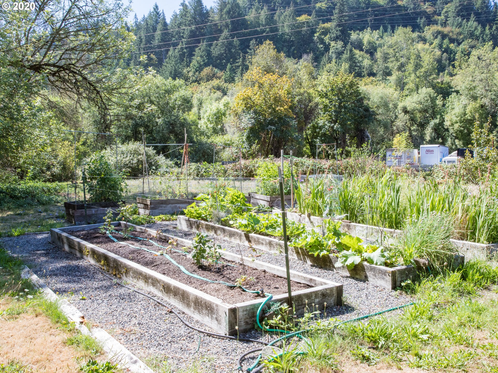 14998 Northwest Mill Road, Unit D Portland, OR 97231 - Photo 29 of 32 a view of a garden with a bench