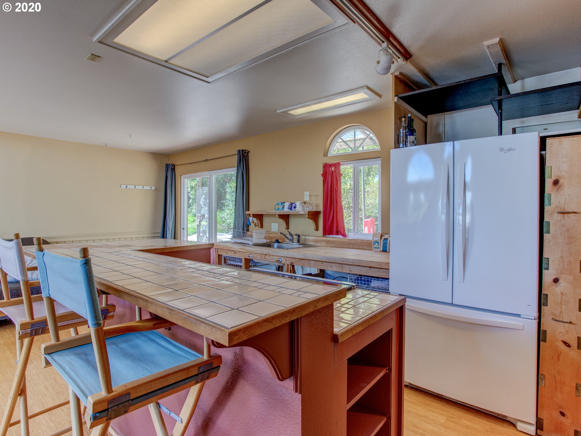 14998 Northwest Mill Road, Unit D Portland, OR 97231 - Photo 8 of 32 a view of a kitchen area with furniture and window