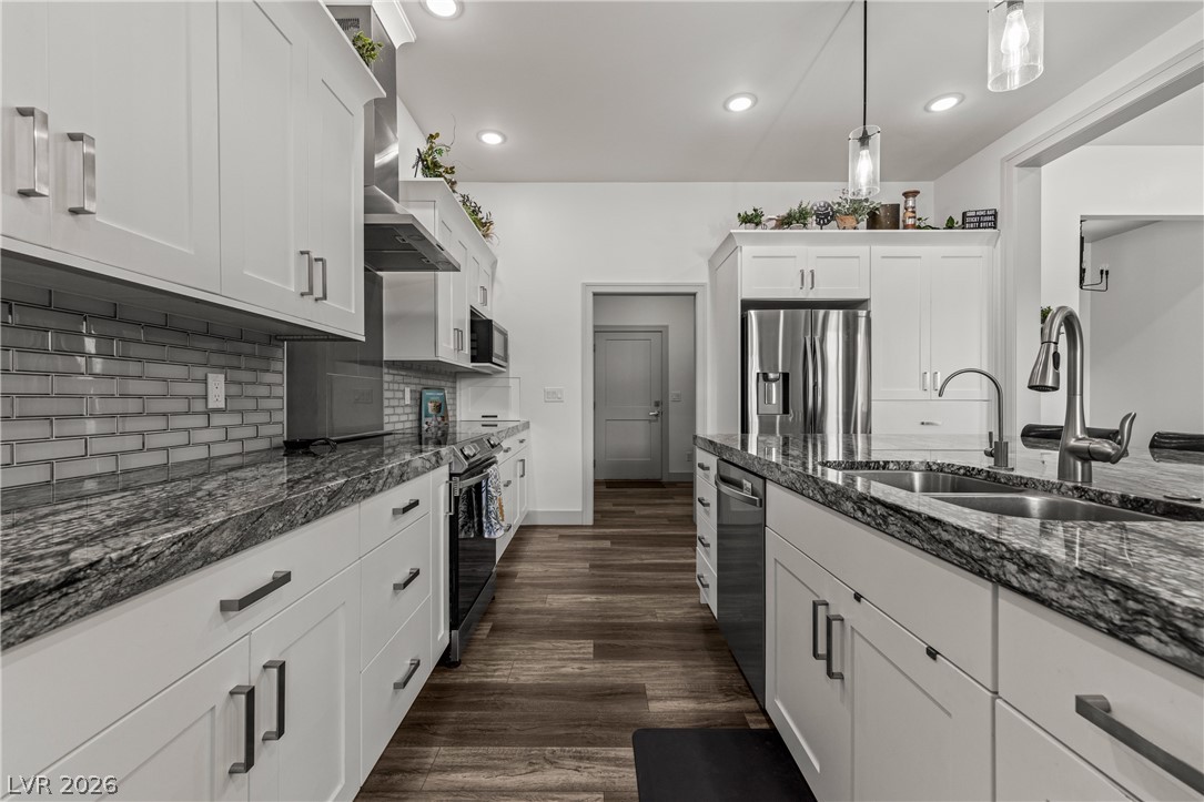 3020 Hannig Street Logandale, NV 89021 - Photo 17 of 75 A sleek modern kitchen showcases stainless steel appliances and abundant counter space.
