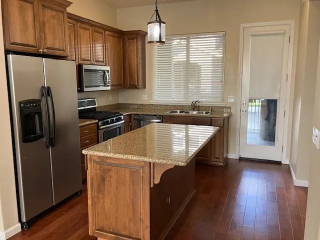 a kitchen with a sink cabinets and a window