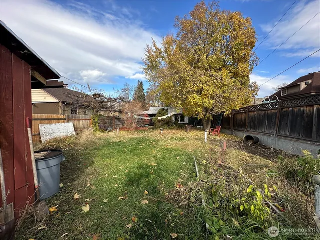 a view of backyard with plants and outdoor seating