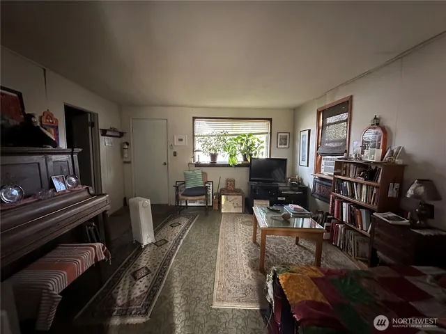 a living room with furniture and a bookshelf