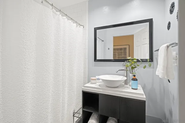 a bathroom with a sink vanity and a mirror