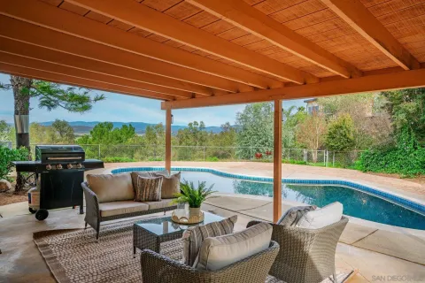 a patio with yard glass top table and chairs