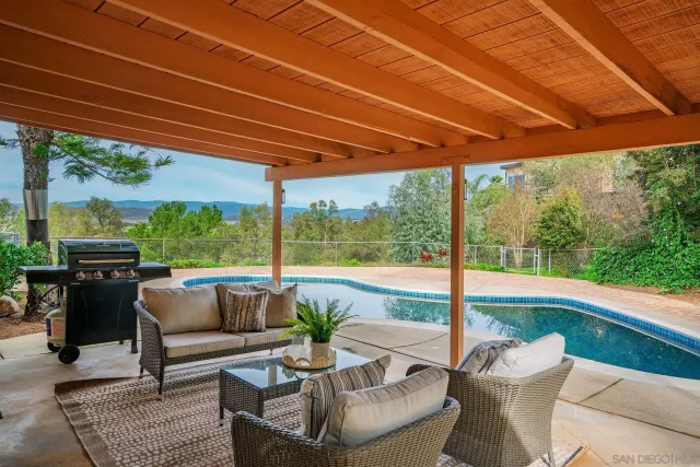 a patio with yard glass top table and chairs