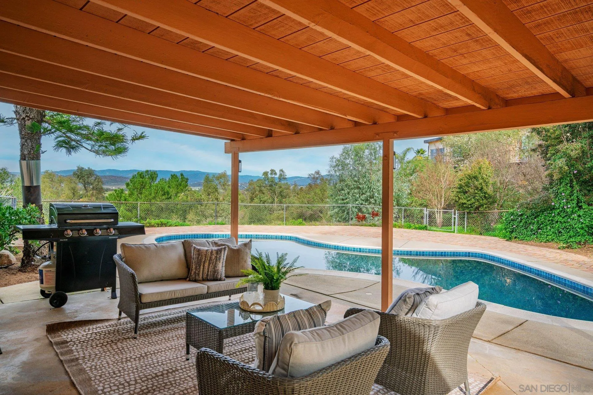 15770 Oak Valley Road Ramona, CA 92065 - Photo 20 of 28 a patio with yard glass top table and chairs