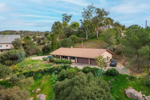 an aerial view of a house with yard and outdoor seating