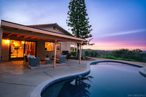 a backyard of a house with outdoor seating