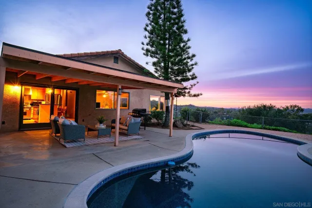a backyard of a house with outdoor seating
