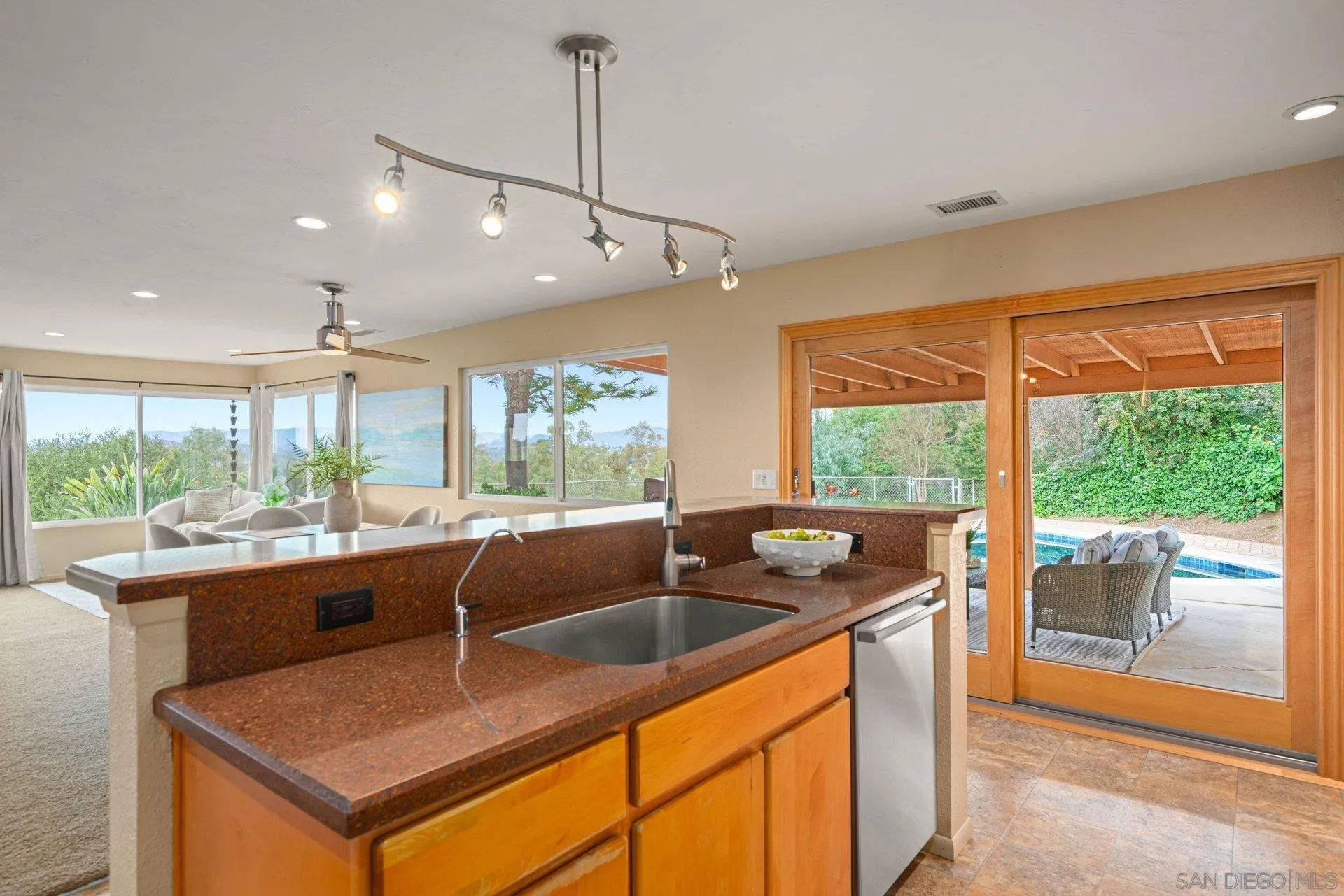 15770 Oak Valley Road Ramona, CA 92065 - Photo 9 of 28 a kitchen with a sink and large windows