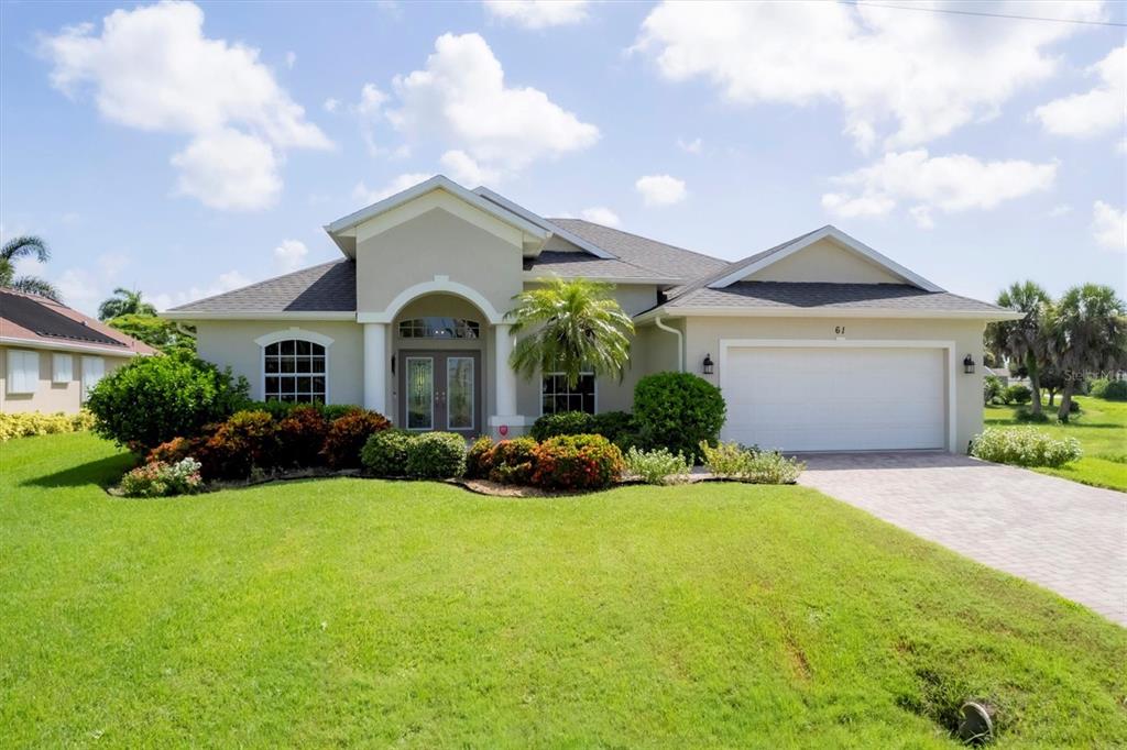 61 Tournament Road Rotonda West, FL 33947 - Photo 1 of 1 a front view of a house with yard and green space
