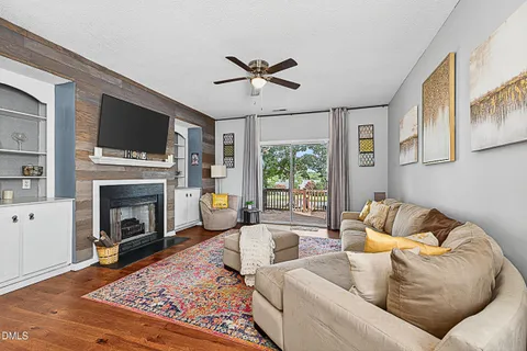 a living room with furniture fireplace and flat screen tv
